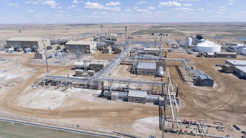Aerial view of a CO₂ enhanced oil recovery facility with pipelines and processing units