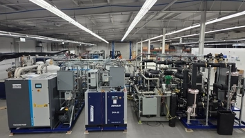 Atlas Copco vacuum pump and Denair DVA-22 compressor with dense processing equipment on a warehouse floor